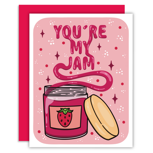 Strawberry jam that spells out you’re my jam out of a jar on a greeting card.