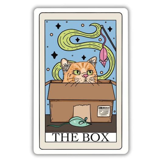 The Box Tarot Card Vinyl Sticker. An orange cat looking at a mouse cat toy while sitting in a cardboard box on a blue background on a tarot card vinyl sticker.