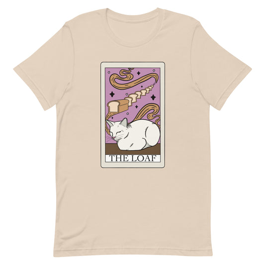 The loaf tarot card t-shirt in soft cream. A white cat loafing with bread on tarot card with text the loaf. Keywords: funny cat meme shirt, cat lover gifts under 30, cat parent shirt, kitten shirt, white cat