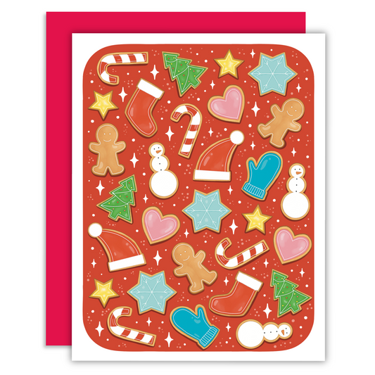 Christmas cookies on a red background. The cookies are shaped into snowmen, gingerbread, mittens, snowflakes, christmas trees, stars, hearts, and candy canes.