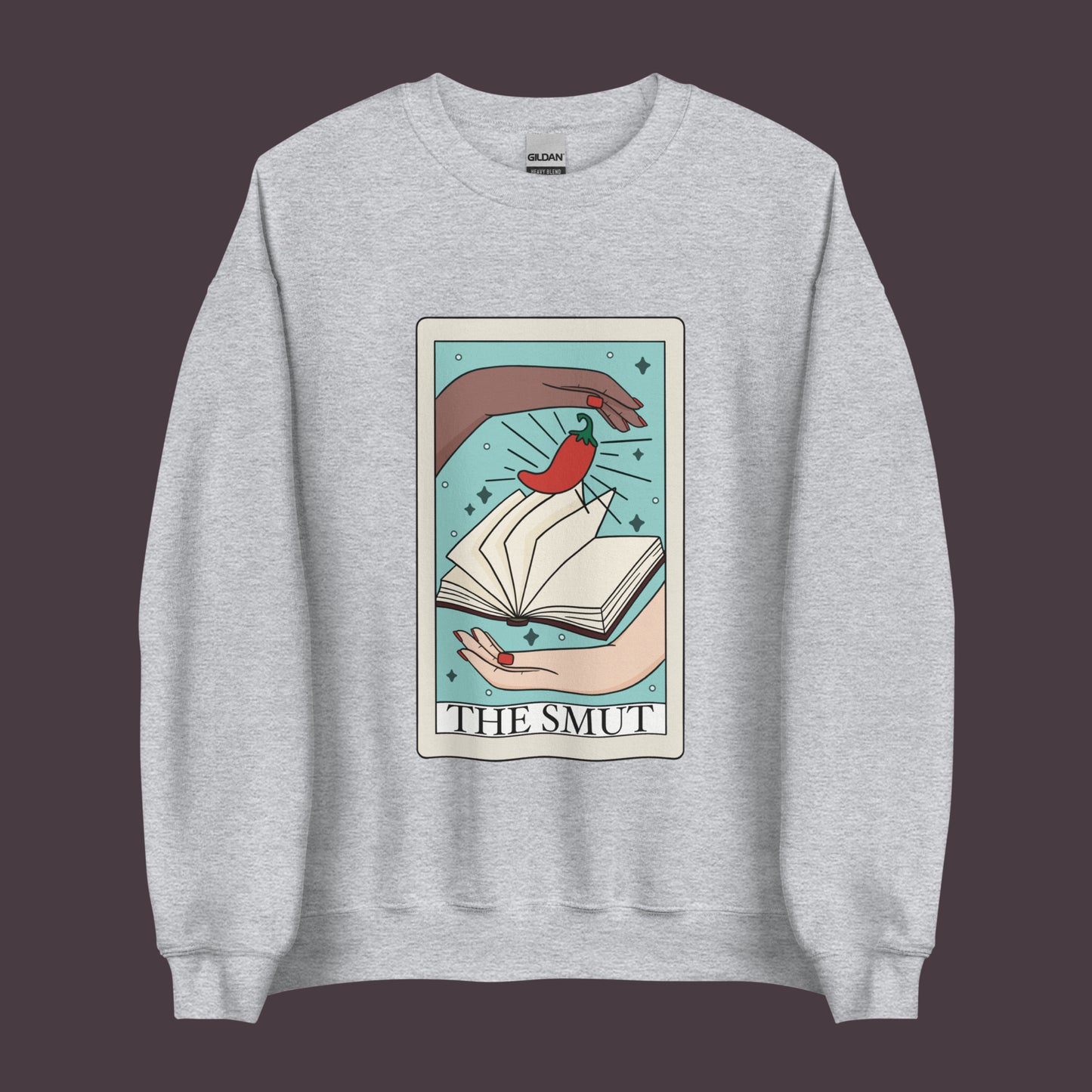 The smut tarot card sweatshirt in color grey, two hands with book and chilli pepper on tarot card with text that says the smut. Keywords: bookish, bookworm, fantasy romance, dark romance, spicy books, smut reader,