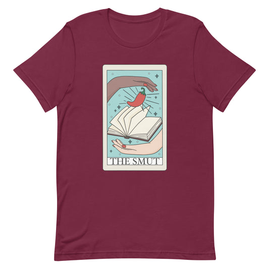 The smut tarot card t-shirt in color maroon, two hands with book and chilli pepper on tarot card with text that says the smut. Keywords: bookish shirt, bookworm tee, fantasy romance, dark romance, spicy books, smut reader, monster romance, bookish merch